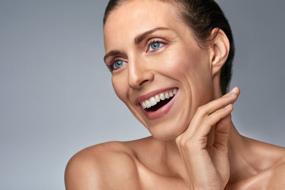 Beautiful woman laughing in studio, beauty fresh skin care concept